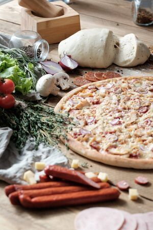pizza with meat with ingredient on the wooden table in rustik styleの写真素材