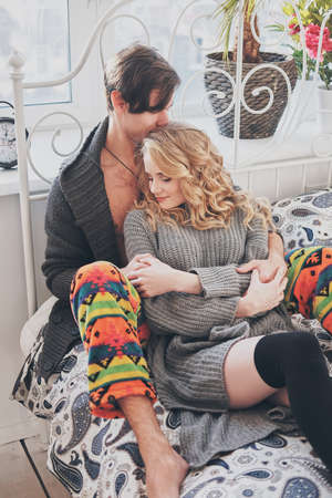 attractive man and woman in the bedroom together cuddling cute