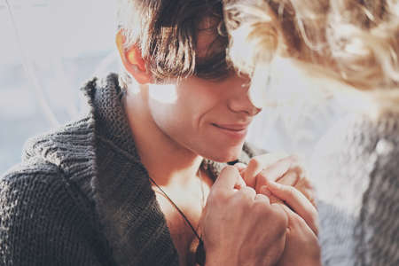 attractive man and woman in the bedroom together cuddling cute