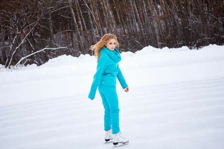 Side view of young woman skating on ice rink