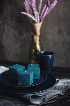 Blue cake filled with orange and tangerine in the shape of a cube. Rustic style.の写真素材