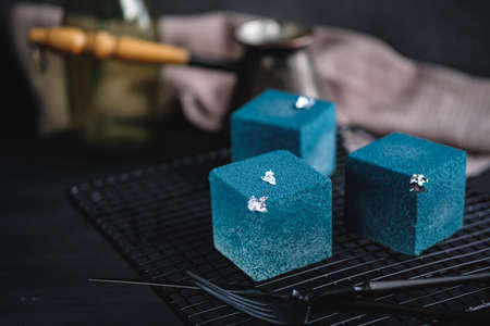 Blue cake filled with orange and tangerine in the shape of a cube. Rustic style.の写真素材