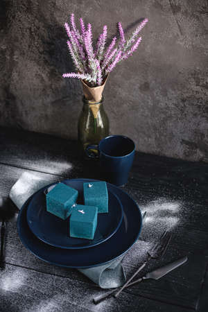 Blue cake filled with orange and tangerine in the shape of a cube. Rustic style.の写真素材