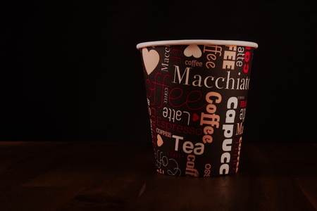 Paper cup of coffee on black backgroundの写真素材