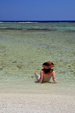 woman with hat on a beach marsa alam egyptの写真素材