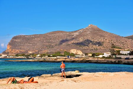 panorama of the coast of the island and tourists and bathers on the cliff September 26 2019 Favignana Sicily Italyのeditorial素材