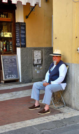 characteristic picturesque character in front of the wine shop May 30 2020 Imperia Italyのeditorial素材