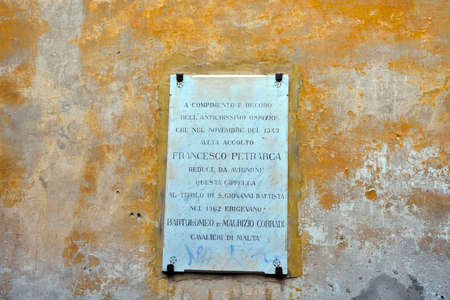 plaque where it says that in 1343 it was housed in the ancient hospice the poet francesco petrarca in porto maurizio May 31 2020 Imperia Italyのeditorial素材