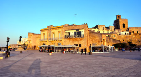 sunset and tourists on the promenade walk of the heroes 4 May 2018 Otranto Salento Italyのeditorial素材