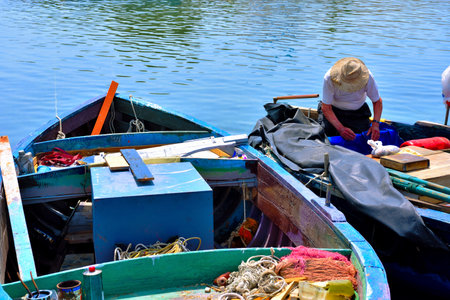 fisherman in the harbor April 29 2018 Porto Cesareo Italyのeditorial素材