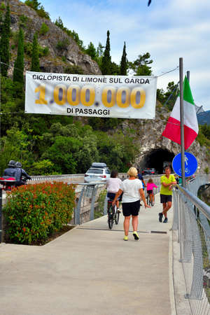 banner at the beginning of the cycle path on Lake Garda indicates the passage of a million people 29 Aug 2021 Limone sul garda Italyのeditorial素材
