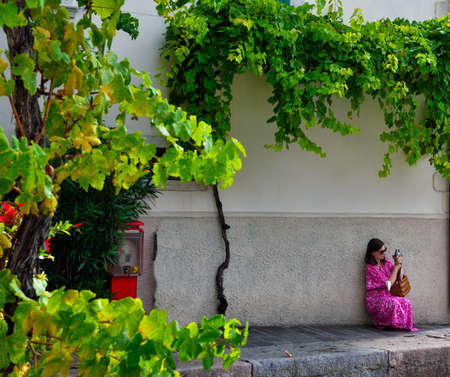 beautiful girl photographs the lake landscape28 Aug 2021 Limone sul garda Italyのeditorial素材