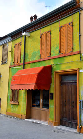 Small Italian town Comacchio also known as "The Little Venice", Emilia Romagna region, province of Ferrara, Italy: Colored houses in traditional architectural styleの写真素材