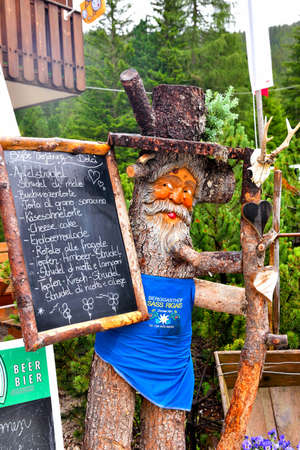 Wood carvings made by an anonymous artist near an alpine hut - July 6 2018 Val di Funes South Tyrol Italyのeditorial素材