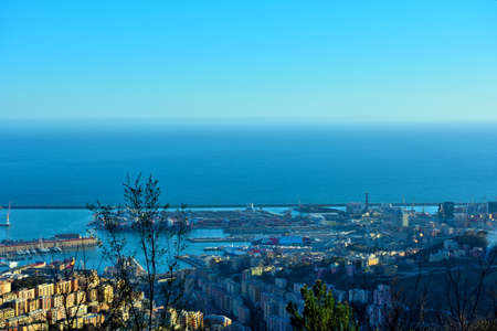 urban panorama and the sea and commercial port Genoa, Italyの写真素材