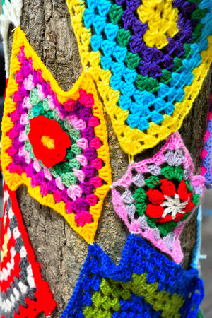 colorful crochet doilies on trees in vittorio emanuele square Enna Sicily Italy