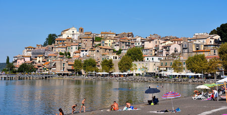 the historic center and swimmers and tourists in Lake Bracciano10 Sep 2023 Anguillara Sabaziaのeditorial素材
