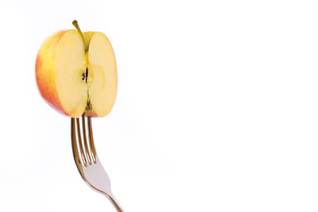 Concept of vegetarian food. Apple on forkの写真素材