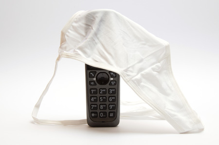 Concept of Stalking. Telephone with panties for womenの写真素材