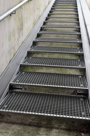 industrial metal stairs with concrete wallの写真素材