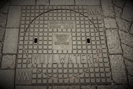 Metal wastewater manhole cover in streetの写真素材