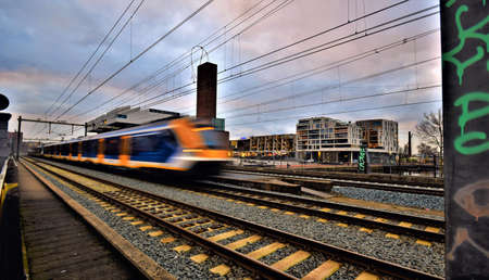 Cityscape in sunset with clouds , buildings and driving trainの写真素材