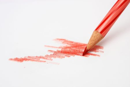 A red color pencil sketching and coloring on a white paperの写真素材