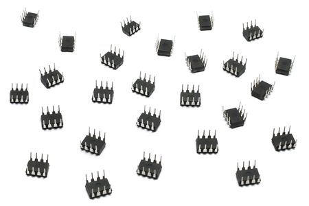 A pile of eight lead microchips scattered over white surface.の写真素材