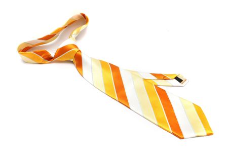An orange necktie with stripe on white background.の写真素材