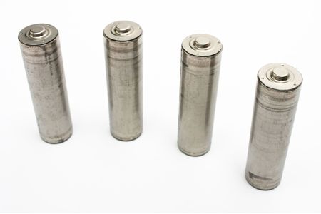 Four AA size battery standing on white background.