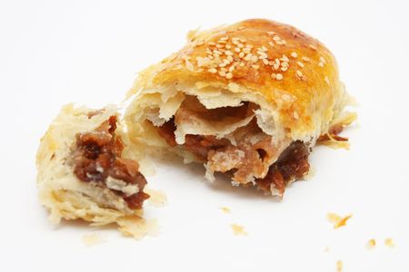 A barbecued chicken pastry tear into half.