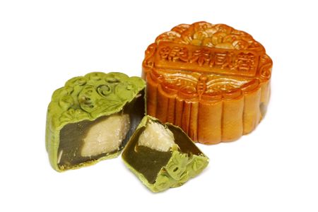 A greentea mooncake slice into pieces over white background.の写真素材