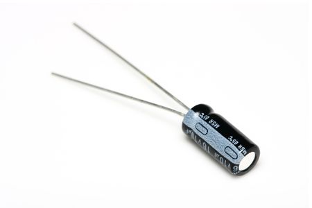 A capacitor lay down and isolated on white surface.