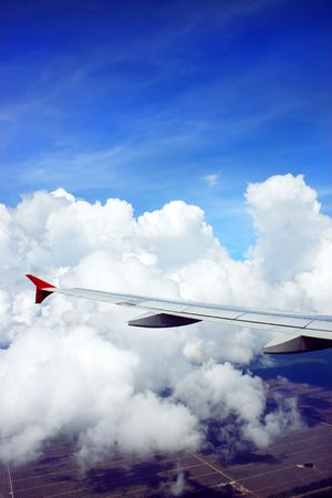 Aerial view of cloudy sky from airplane window.