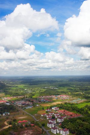 Aerial view of cloud over river and residential area.の写真素材