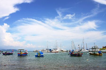 A few fishing boat docking beside the jetty.の写真素材
