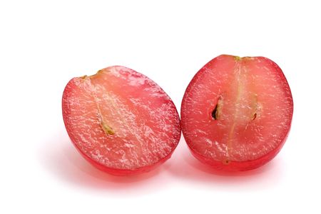 A red grape sliced into half isolated on white background.の写真素材