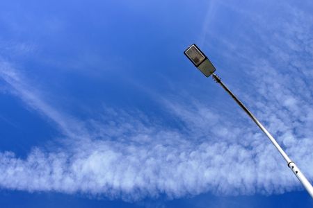 A street light with blue sky as background.の写真素材