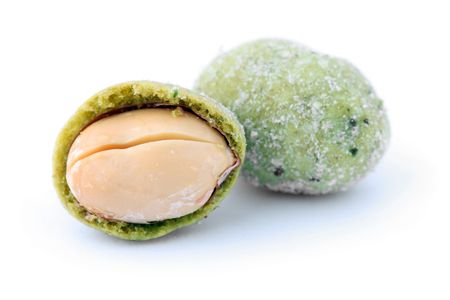 Close up of wasabi peanut snack balls isolated over white background.の写真素材