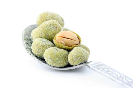 Close up of wasabi peanut snack balls isolated over white background.の写真素材