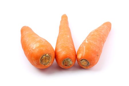 Three orange carrots isolated on white background.の写真素材