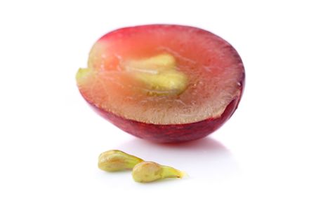 An half grape with seeds isolated over white background.の写真素材