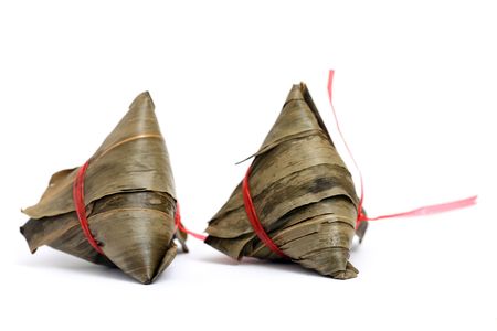 Close up of three rice dumplings over white background.の写真素材
