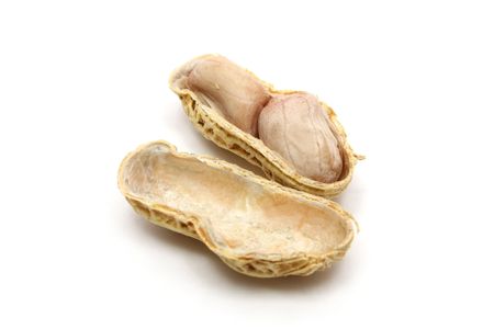 A well peanut beside peeled peanut isolated on white background.