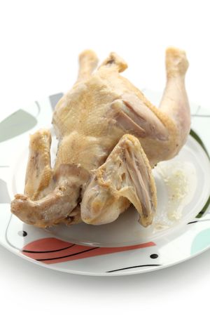 Close up of a whole chicken isolated over white background.の写真素材