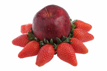 Red apple surrounded with strawberries isolated on white background.の写真素材