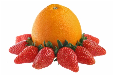 An orange surrounded with strawberries isolated on white background.の写真素材