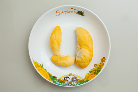 Close up of peeled durian in plate on granite surface.の写真素材