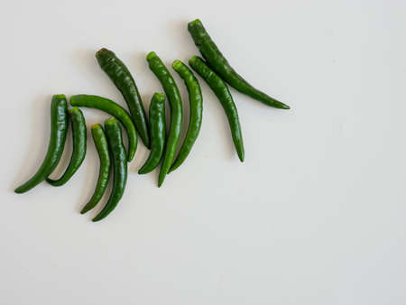 fresh green chili isolated on white backgroundの写真素材