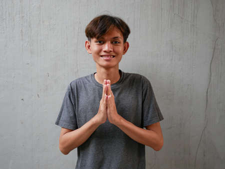 young asian man with an apologetic expressionの写真素材